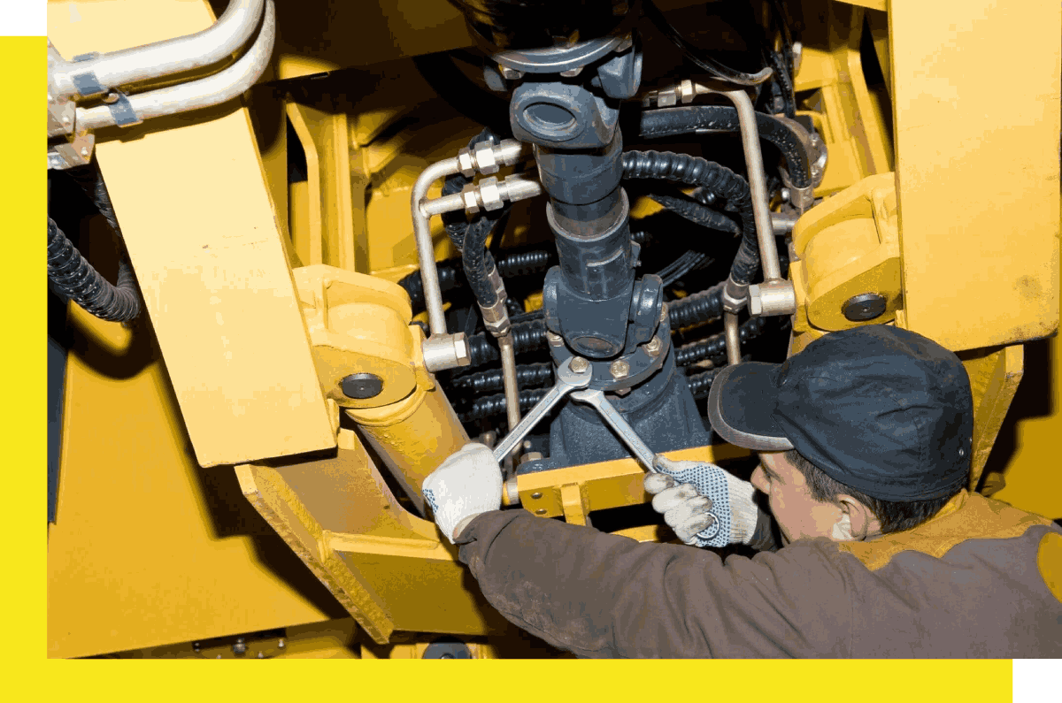 A person working on the bottom of an engine.