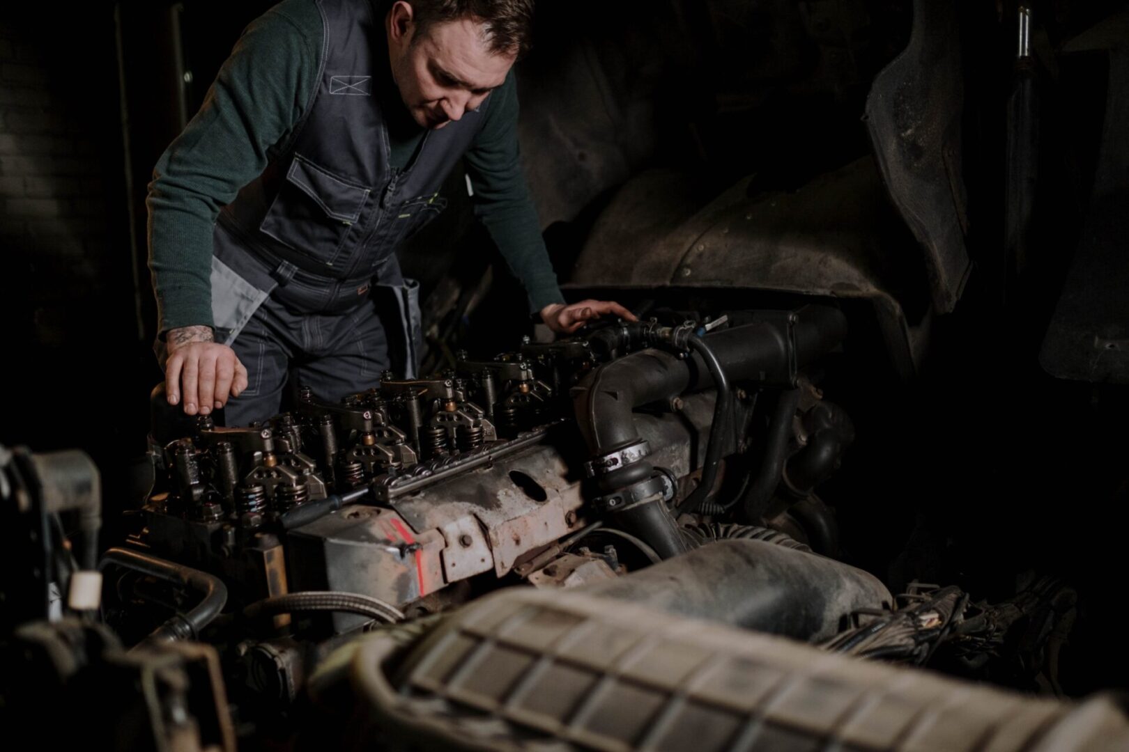 A man working on an engine in the middle of a cave.