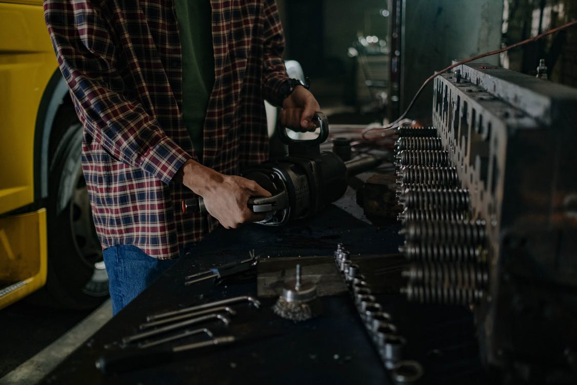 A man working on some tools in a room.